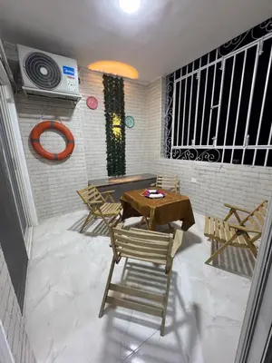 a patio with a table and chairs in a room at شقه لك ب الكامل فندقي in Safaga