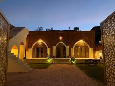 a building with a courtyard with lights on it at Temple Of The Golden Sun in Luxor