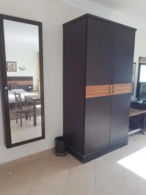 a large black cabinet in a room with a mirror at Sunset Barrel in Hurghada