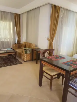 a living room with a table and a couch at Sunset Barrel in Hurghada