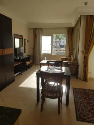 a living room with a table and a couch at Sunset Barrel in Hurghada