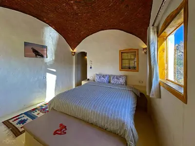 a bedroom with a bed in a small room at ASSINGAR Island in Aswan