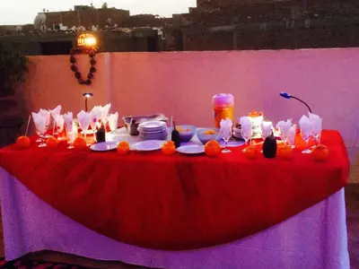 a red table with food and candles on it at Sphinx in Al Karnak