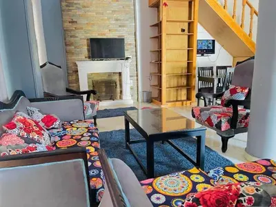 a living room with a couch and a fireplace at Entire Oasis Villa - Heart of Ancient Luxor in Luxor