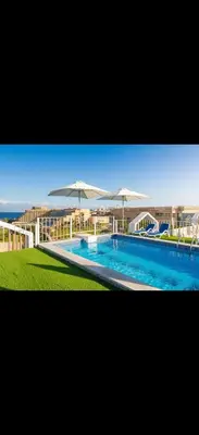 a large swimming pool with umbrellas in the background at Luxury Panorama Sea View Residence with sky pool in Hurghada