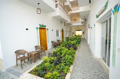 a corridor of a building with a garden at Astralis Hotel - Hot Air Balloon View in Al Aqālitah