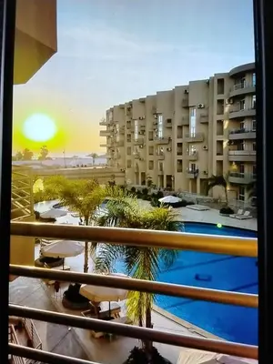 a view from a balcony of a building with a pool at Hurghada Pool & See View Studio in Hurghada