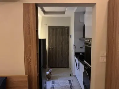 a kitchen with a door leading to a kitchen with a stove at Panorama view in Hurghada