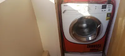 a washer and dryer in a corner of a room at D Guest house in Nag` el-Ramla