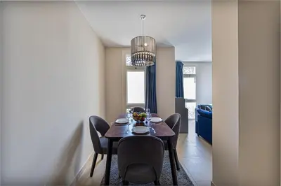 a dining table and chairs in a living room at Serenity Pool View Holiday Home in Hurghada