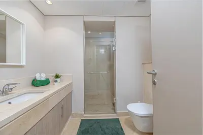 a bathroom with a shower and a toilet and a sink at Serenity Pool View Holiday Home in Hurghada