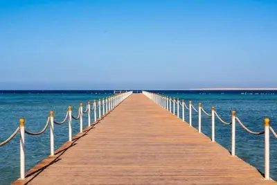 a wooden pier stretches out into the ocean at scandic Beach Hurghada in Hurghada