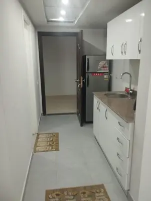 a kitchen with a sink and a refrigerator at scandic Beach Hurghada in Hurghada