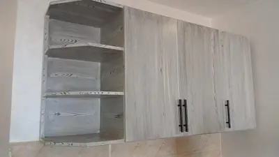 a wooden cabinet with glass doors in a room at شقه بمنتجع كذابلانكا in Hurghada