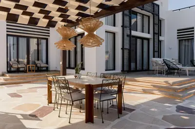 a dining room with a table and chairs at The Reef House Luxury Waterfront Villa in Hurghada