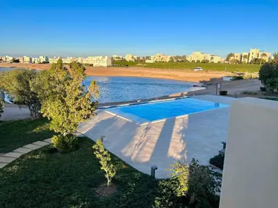 an overhead view of a pool of water with a city at Cozy 1-bedroom Joubal lagoon apartment in Hurghada