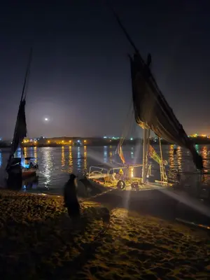 a sail boat on the beach at night at Aswan all-inclusive private felucca in Aswan