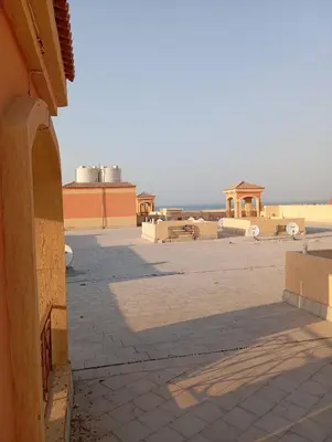 a view of a patio with a building in the background at Red Ruby chalets &flats HRG,Elgouna in Hurghada