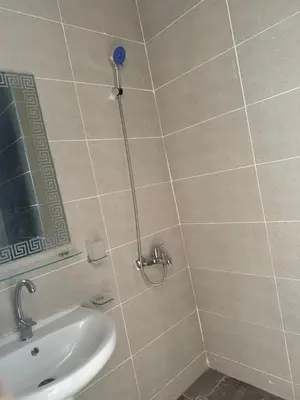 a bathroom with a shower with a sink and a mirror at Aqua infinity resort in Hurghada