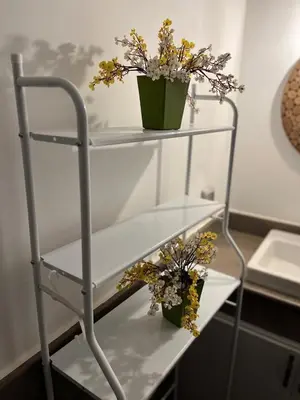 a white shelf with two potted plants on it at Elegant Studio in El Gouna in Hurghada