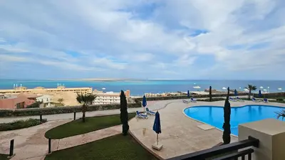 a view of a swimming pool and the ocean at Exklusive Ferienwohnung mit traumhafter Meeressicht in Hurghada