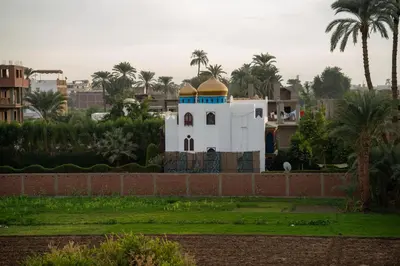 a building with a dome on top of a wall at Queen of Merit in Luxor