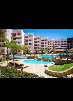 a resort with a swimming pool and some buildings at قريه الدهبيه in Hurghada