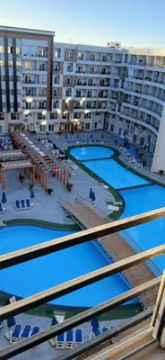 a view of a large apartment complex with swimming pools at Hurghada Tiba Golden Beach Resort Down Town in Hurghada