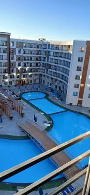 a view of the pool from the balcony of a apartment building at Hurghada Tiba Golden Beach Resort Down Town in Hurghada