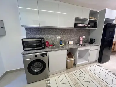a kitchen with a washing machine and a sink at Maraya El Gouna in Hurghada