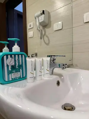 a bathroom sink with three rolls of toilet paper on it at Two-bedroom apartment in G Cribs in Hurghada