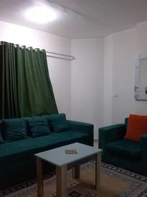 a living room with a couch and a coffee table at Rich Home Hurghada in Hurghada