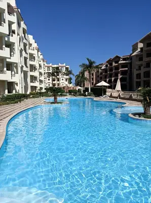 a large swimming pool in front of some buildings at All View Apartements, Sahl Hasheesh, El Andalous in Hurghada