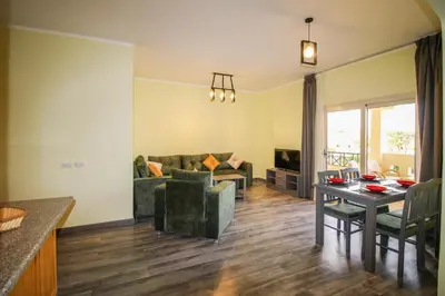 a living room with a table and a couch at All View Apartements, Sahl Hasheesh, El Andalous in Hurghada