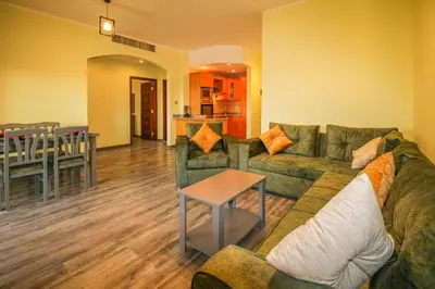 a living room with a green couch and a table at All View Apartements, Sahl Hasheesh, El Andalous in Hurghada