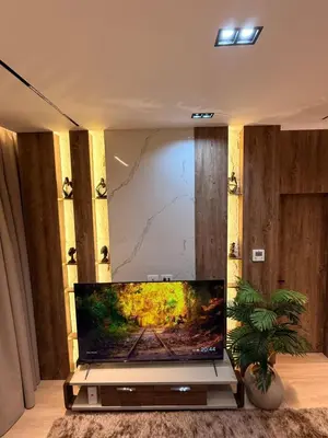 a flat screen tv sitting on a stand in a living room at Luxury Sea View Apartment Near Hurghada Airport in Hurghada