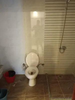 a bathroom with a white toilet in a room at ميراج باى in Hurghada