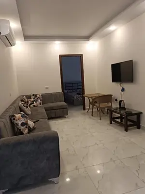 a living room with a couch and a table at ميراج باى in Hurghada