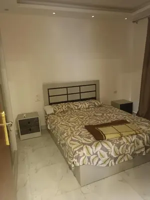 a bedroom with a bed in a white room at ميراج باى in Hurghada