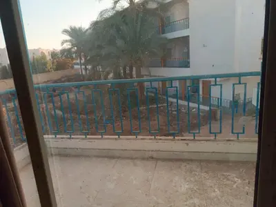 a view from a window of a balcony with palm trees at ميراج باى in Hurghada