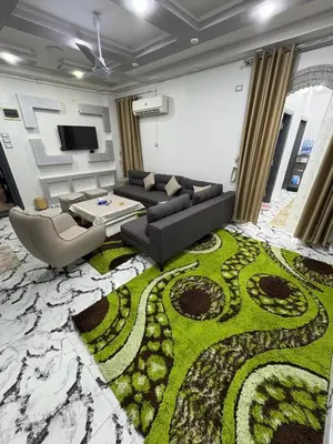 a living room with a couch and a table at fayrouz in Al Aqālitah