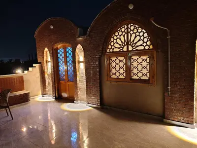 a brick building with a door and a window at Nefertari Palace apartments in Al Aqālitah