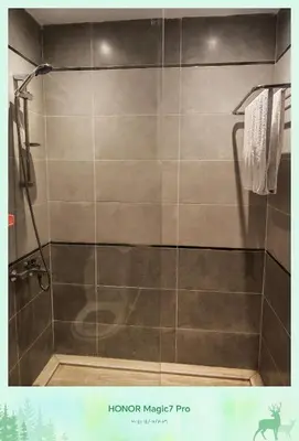 a bathroom with a shower with a glass door at Hambra avenue resort in Hurghada