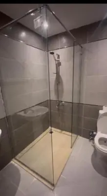 a glass shower in a bathroom with a toilet at Humbra in Hurghada