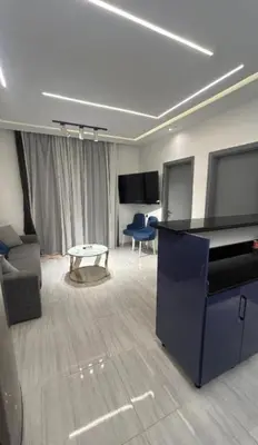a living room with a grand piano and a couch at Humbra in Hurghada
