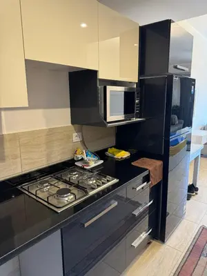 a kitchen with a stove and a microwave at Lotus Al-Dau Heights in Hurghada