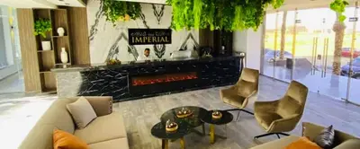 a living room with a couch and a fireplace at Imperial Resort App 433 in Hurghada