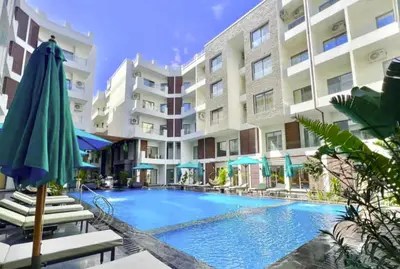 a swimming pool in front of a building at Imperial Resort App 433 in Hurghada