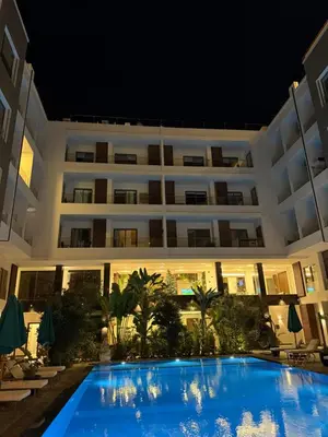 a hotel with a large swimming pool at night at Imperial Resort App 433 in Hurghada