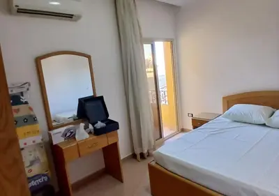 a bedroom with a bed and a mirror and a mirror at Modern Apartment in the Britsh Resort in Hurghada